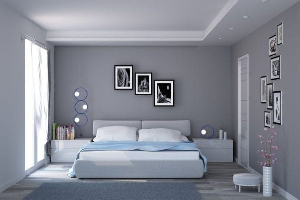 Kamar tidur minimalis dengan dinding abu-abu dan tempat tidur sederhana